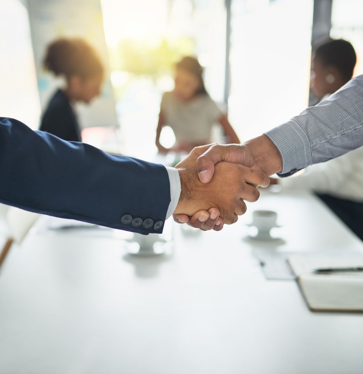 A Business Meeting With Two People Shaking Hands